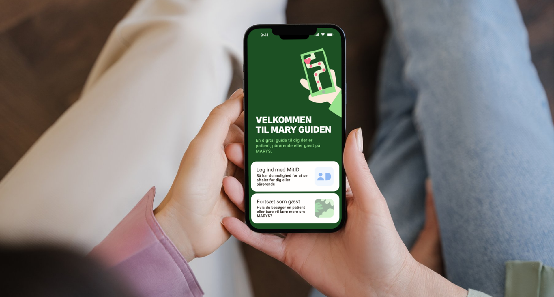 MARY Guide — person holding a phone showing the Velkommen til Mary Guiden welcome screen